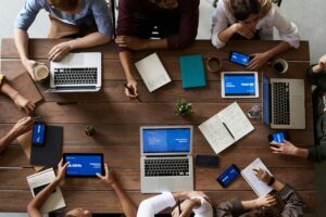 Top view photo of people near wooden table
